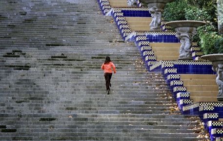 A person climbing a large set of stairs